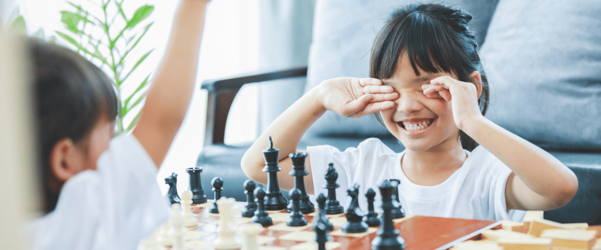 Kids playing chess in a comfortable home