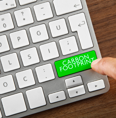 A person presses a carbon footprint button on a keyboard